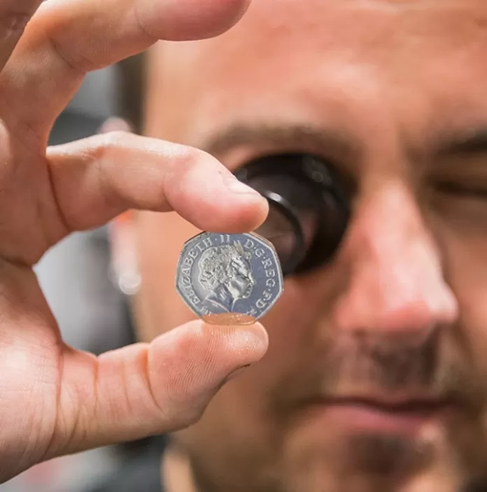 Man inspecting a coin