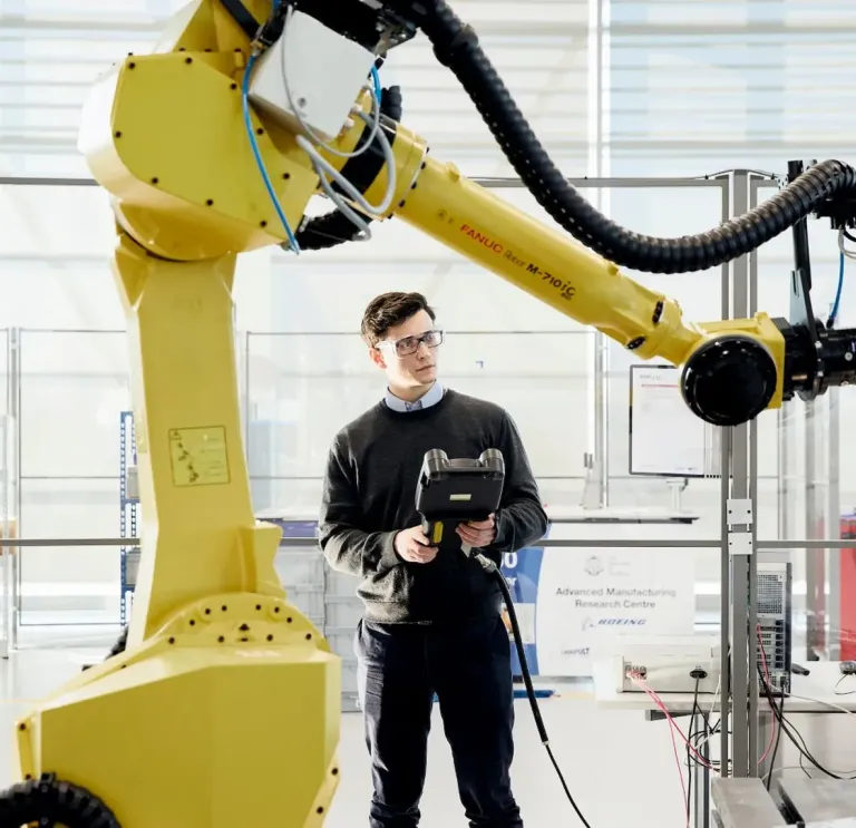 Man operating a robot arm