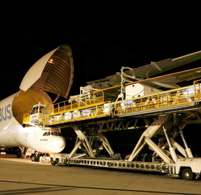 Wing being loaded onto an aircraft