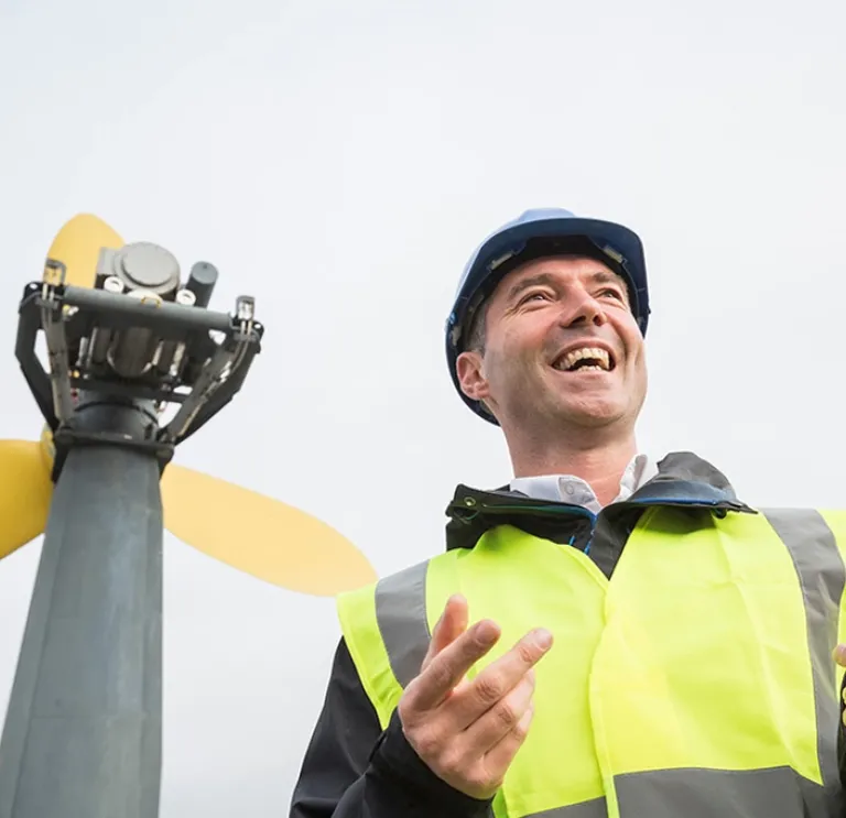 Man by a wind turbine