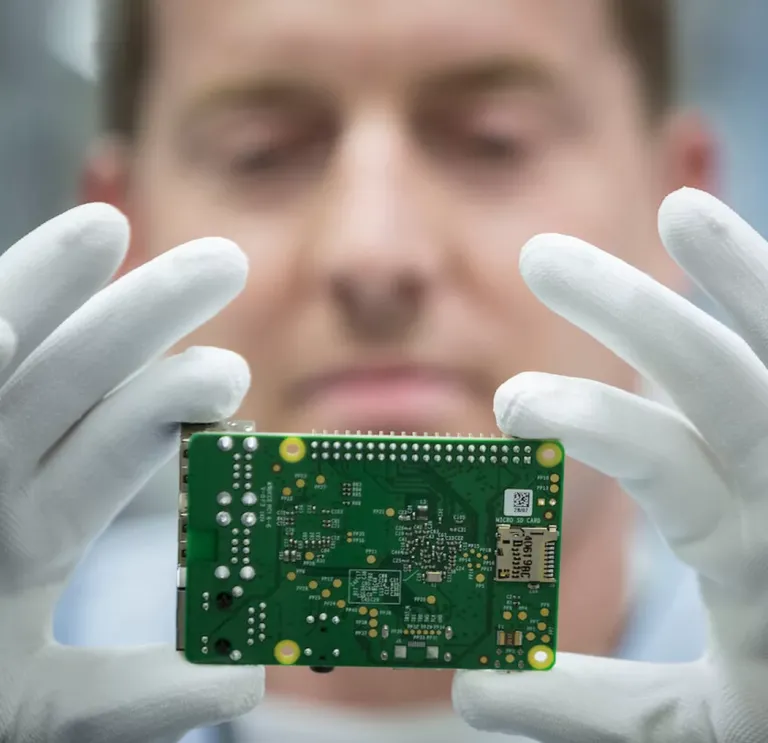 Man holding up a circuit board