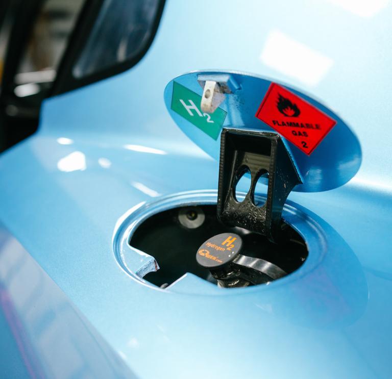 Car fuel cap open for hydrogen