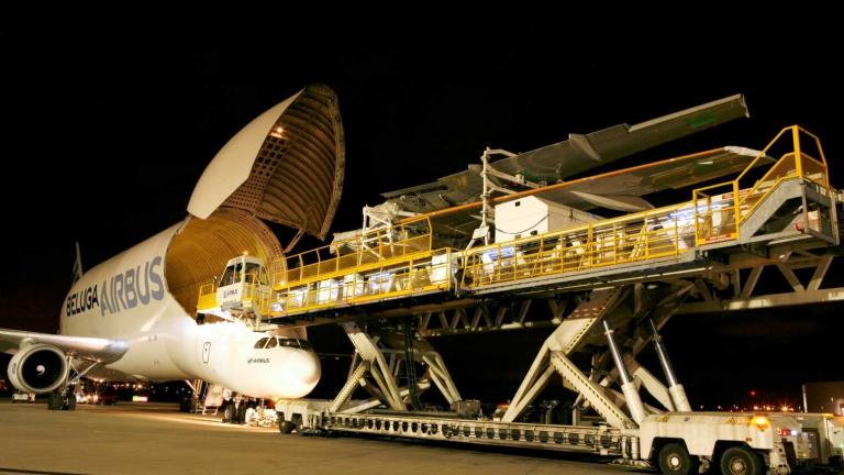 Wing being loaded onto an aircraft