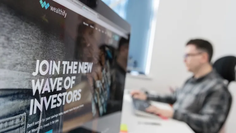 Computer screen with man in the background