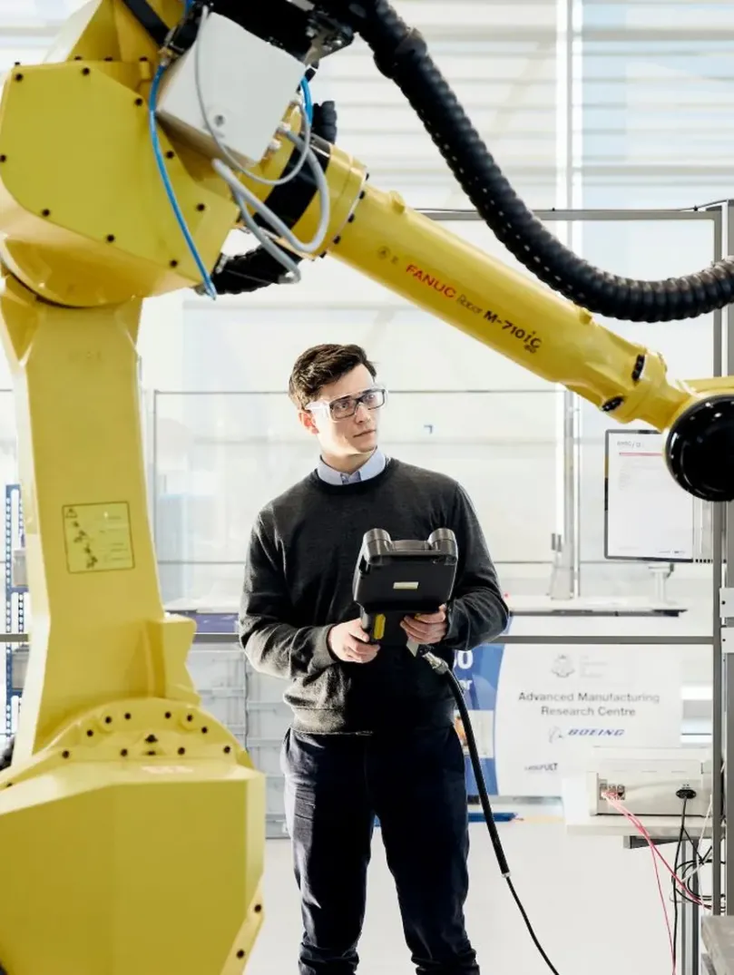 Man operating a robot arm