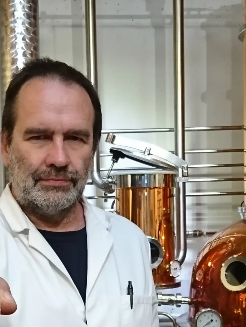 Man holding up a bottle at a distillery 