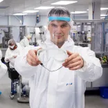 Man holding up safety googles